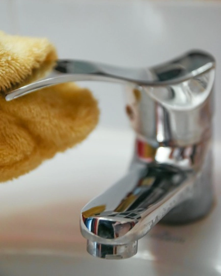 bathroom tap being cleaned