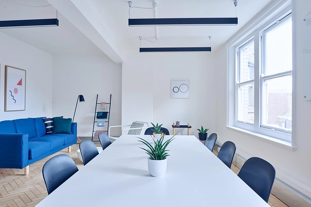 White office table with blue chairs
